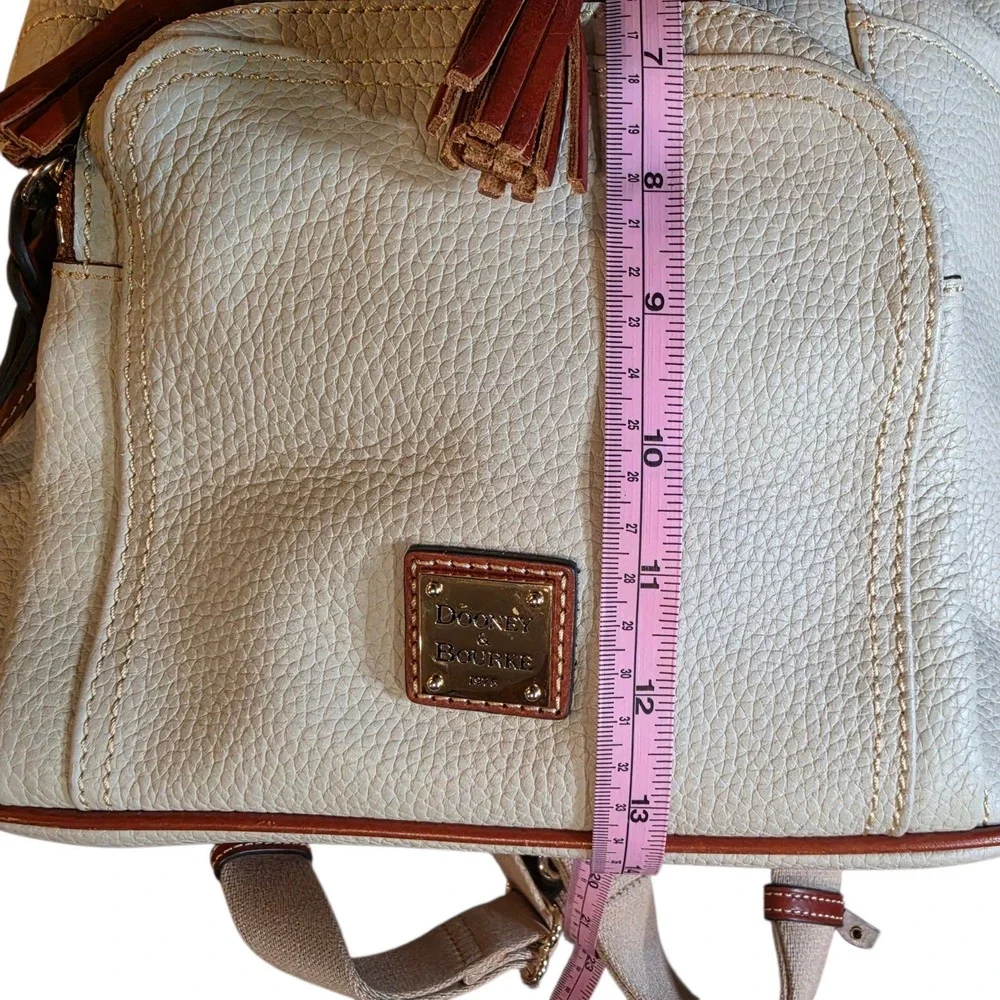 Dooney & Bourke Pebbled Leather Drawstring Backpack White Tan Tassel Logo